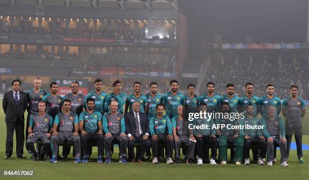 Pakistani cricketers pose for a photograph along with Chairman Pakistan Cricket Board , Najam Sethi at the Gaddafi Cricket Stadium in Lahore on...
