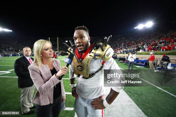 Georgia Davin Bellamy during interview with NBC Sports Kathryn Tappen sideline reporter Notre Dame at Notre Dame Stadium. Bellamy wearing golden...