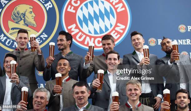 Players raise their glasses during the FC Bayern Muenchen Paulaner photo shoot in traditional Bavarian lederhosen on September 13, 2017 in Munich,...