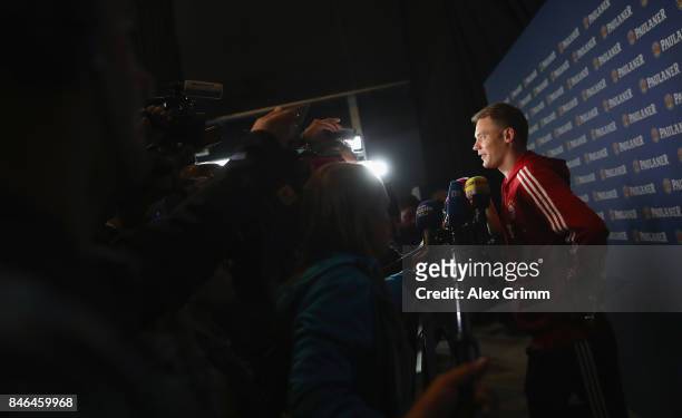 Manuel Neuer talks to journalists during the FC Bayern Muenchen Paulaner photo shoot in traditional Bavarian lederhosen on September 13, 2017 in...