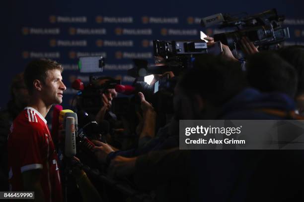 Thomas Mueller talks to journalists during the FC Bayern Muenchen Paulaner photo shoot in traditional Bavarian lederhosen on September 13, 2017 in...