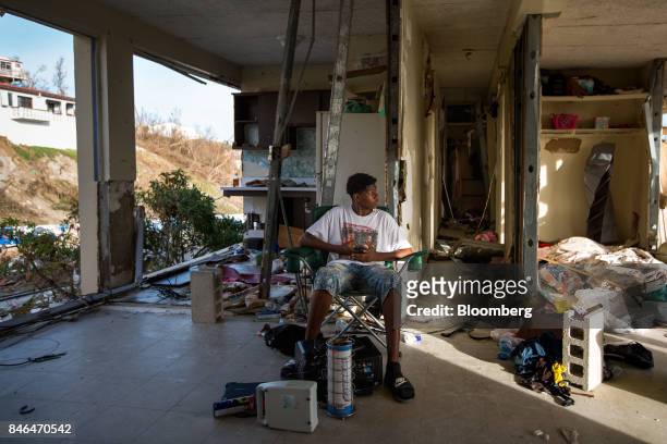 Resident Kimarley Brathweite sits in his grandmother's apartment damaged by Hurricane Irma in St Thomas, U.S. Virgin Islands, on Tuesday, Sept. 12,...