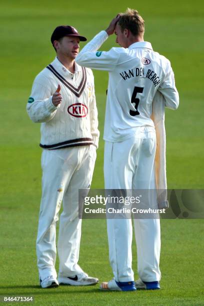 Surrey's Freddie van den Bergh gets advice from captain Gareth Batty during day two of the Specsavers County Championship Division One match between...