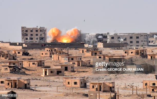 Smoke rises from buildings in the area of Bughayliyah, on the northern outskirts of Deir Ezzor on September 13 as Syrian forces advance during their...