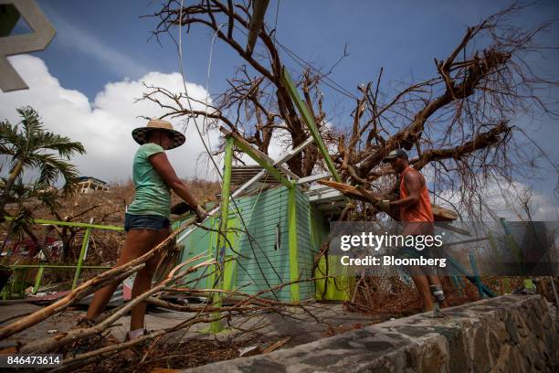 People clean up debris outside of a damaged restuarant after Hurricane Irma at Coral Bay in St John, U.S. Virgin Islands, on Tuesday, Sept. 12, 2017....