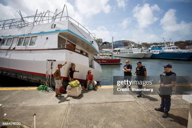 Members of the U.S. Coast Guard stand at an evacuation checkpoint after Hurricane Irma in St John, U.S. Virgin Islands, on Tuesday, Sept. 12, 2017....