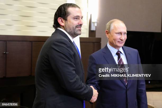 Russian President Vladimir Putin shakes hands with Lebanese Prime Minister Saad Hariri during a meeting in Sochi on September 13, 2017.
