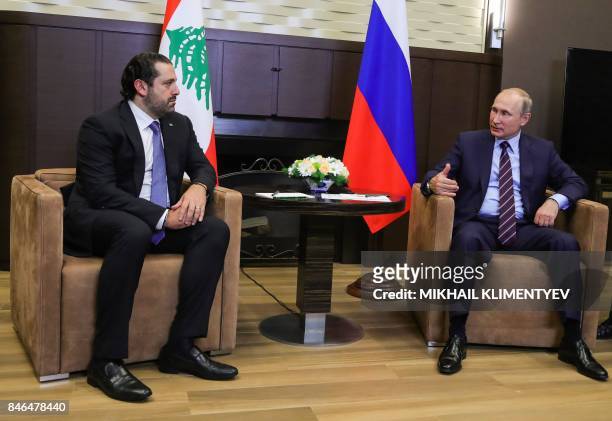 Russian President Vladimir Putin talks with Lebanese Prime Minister Saad Hariri during a meeting in Sochi on September 13, 2017.