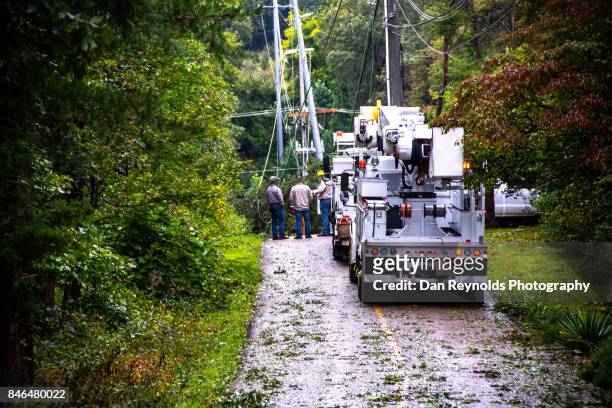 work truck out for repair after storm on wet road - power line truck stock pictures, royalty-free photos & images