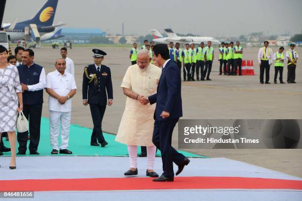 Prime Minister Narendra Modi welcomes Japanese Prime Minister Shinzo Abe upon his arrival at airport, on September 13, 2017 in Ahmadabad, India....
