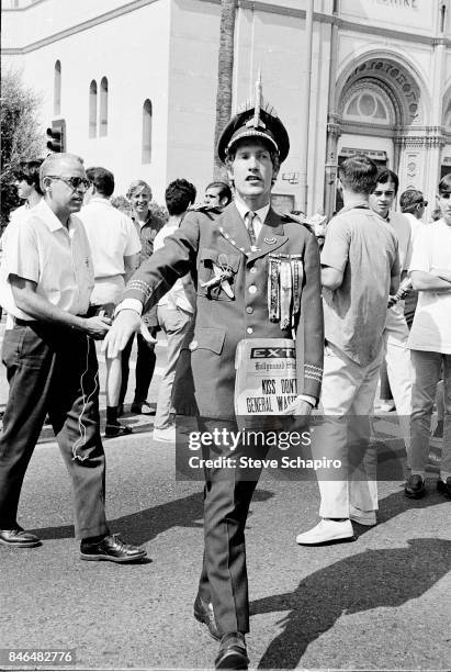 An unidentified protestor, in a parody of a military dress uniform, carries mock newspapers during a anti-Vietnan war demonstration on Wilshire...