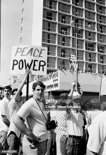 View of protestors during a anti-Vietnan war demonstration on Wilshire Boulevard, Los Angeles, California, 1969. Several carry American flags and and...