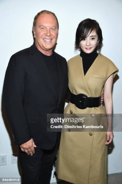 Designer Michael Kors and Yang Mi pose backstage at the Michael Kors Collection Spring 2018 Runway Show at Spring Studios on September 13, 2017 in...