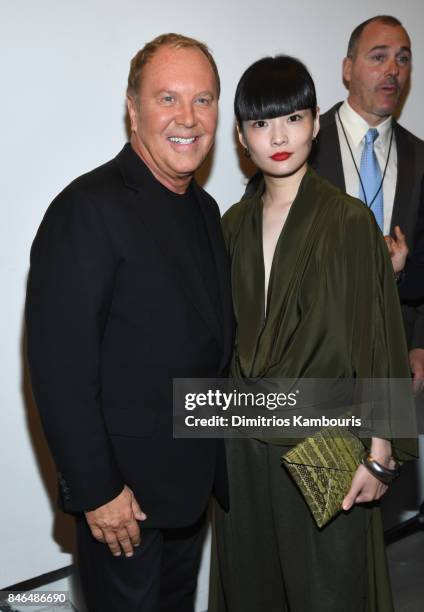 Michael Kors and Kozue Akimoto pose backstage at Michael Kors Collection Spring 2018 Runway Show at Spring Studios on September 13, 2017 in New York...