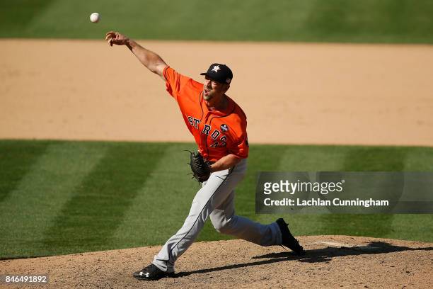Luke Gregerson of the Houston Astros pitches in the eighth inning against the Oakland Athletics at Oakland Alameda Coliseum on September 10, 2017 in...