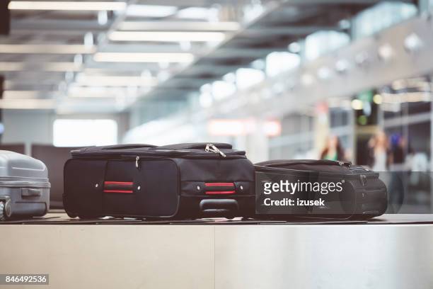 baggage on conveyor belt at the airport - buckle stock pictures, royalty-free photos & images