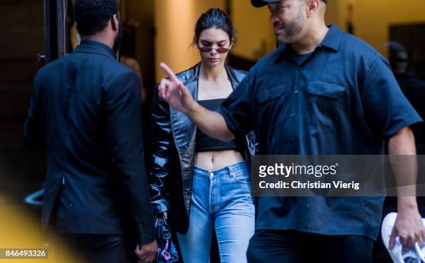 Kendall Jenner wearing cropped top, denim jeans, black jacket seen in the streets of Manhattan outside Michael Kors during New York Fashion Week on...