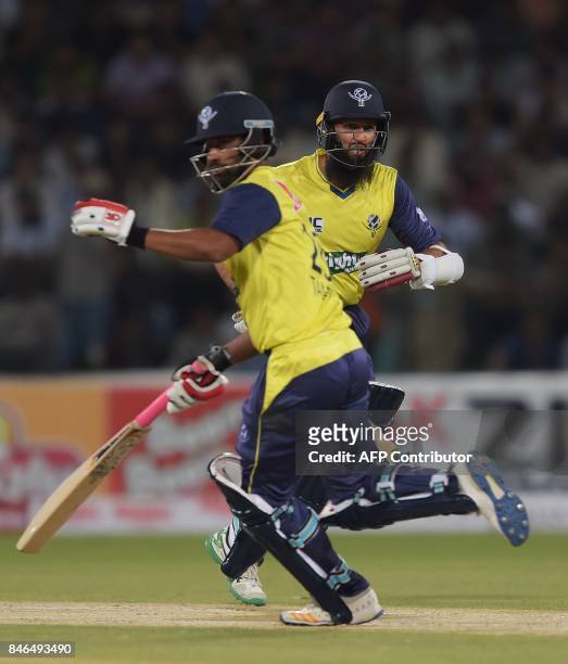 World XI batsmen Hashim Amla and Tamim Iqbal run between the wicket during the second Twenty20 International match between the World XI and Pakistan...