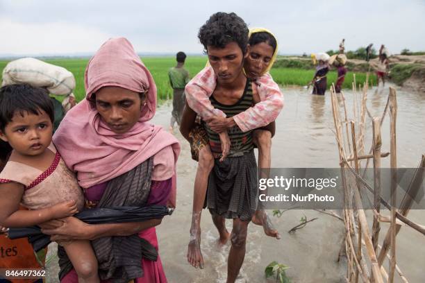 September 08, 2017 Takenuf, Bangladesh - Rohingya people, fled from ongoing military operations in Myanmars Rakhine state, make their way through...