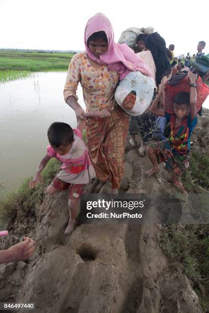 September 08, 2017 Takenuf, Bangladesh - Rohingya people, fled from ongoing military operations in Myanmars Rakhine state, make their way through...