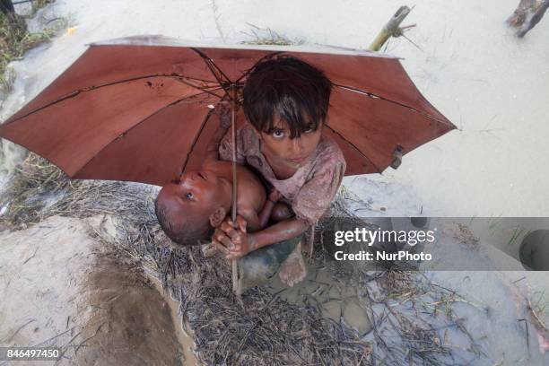 September 08, 2017 Takenuf, Bangladesh - Rohingya people, fled from ongoing military operations in Myanmars Rakhine state, make their way through...