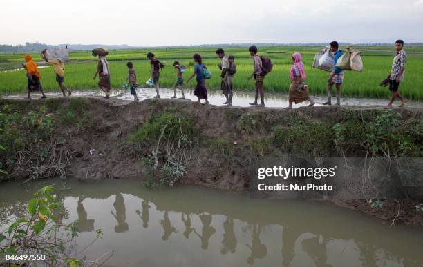 September 08, 2017 Takenuf, Bangladesh - Rohingya people, fled from ongoing military operations in Myanmars Rakhine state, make their way through...