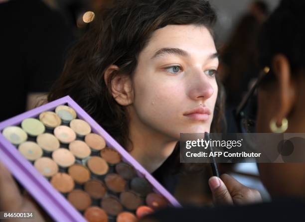 Model prepares backstage for the Michael Kors Collection Spring 2018 Runway Show at Spring Studios on September 13 during New York Fashion Week in...