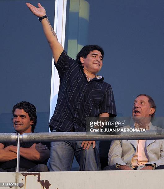 Argentina's national football team coach Diego Maradona waves to the crowd amid Argentine former footballer Alejandro Mancuso and Argentine national...