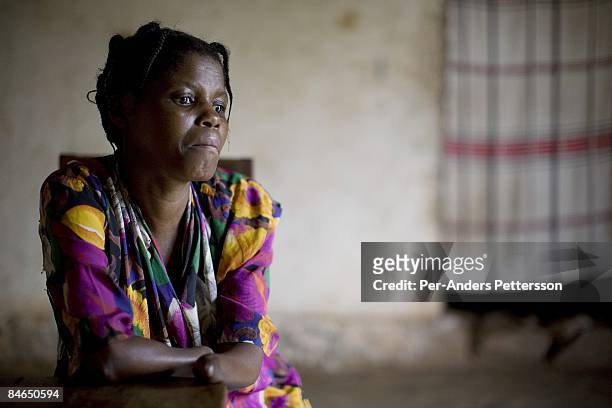 Janette Vumilia, age 30, sits in her living room in her small house on October 29, 2007 Bukavu, DRC. Janette was abducted, held captive and raped by...