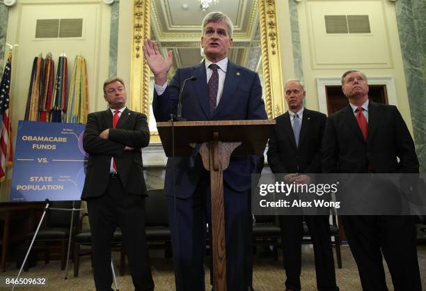 Sen. Bill Cassidy speaks as Sen. Dean Heller , Sen. Ron Johnson and Sen. Lindsey Graham listen during a news conference on health care September 13,...