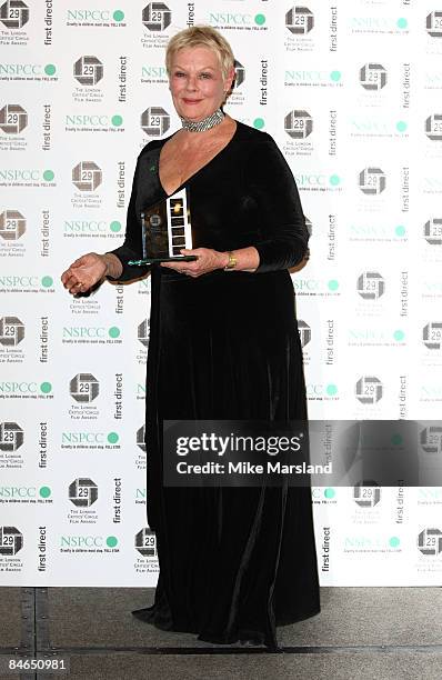 Dame Judi Dench poses with her Dilys Powell Award for Outstanding contribution to cinema at The 29th Annual London Critics' Circle Film Awards at...