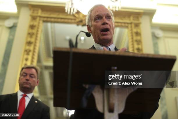 Sen. Ron Johnson speaks as Sen. Dean Heller listens during a news conference on health care September 13, 2017 on Capitol Hill in Washington, DC....