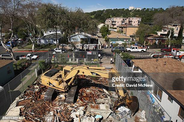 Demolition crew tears down a rented house that city officials say was used as the headquarters of the notorious Avenues gang February 4, 2009 in the...