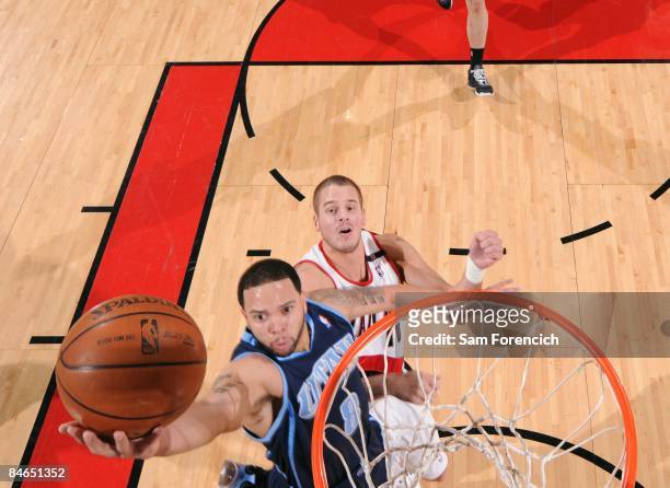 Deron Williams of the Utah Jazz shoots a layup against Joel Przybilla of the Portland Trail Blazers during the game at The Rose Garden on January 31,...