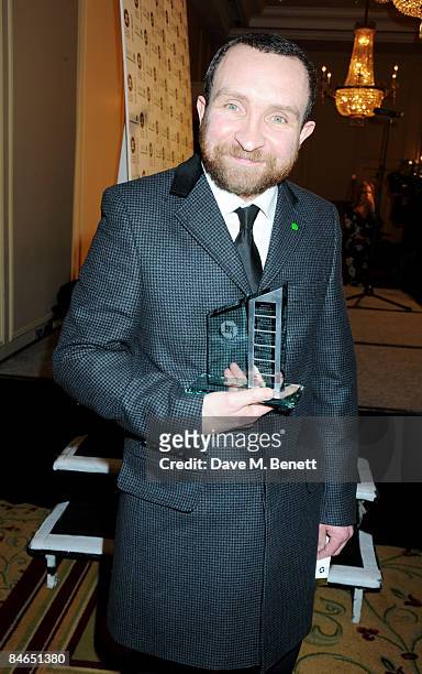 Eddie Marsan poses in the winners room with the award for British actor in a supporting role during the The London Critics' Circle Film Awards 2009,...