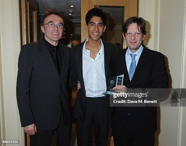 Danny Boyle, Dev Patel and Christian Colson pose in the winners room with the award for British Film of the Year during the London Critics' Circle...