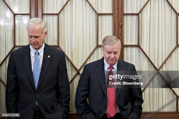 Senator Lindsey Graham, a Republican from South Carolina, right, and Senator Ron Johnson, a Republican from Wisconsin, arrive to a news conference to...