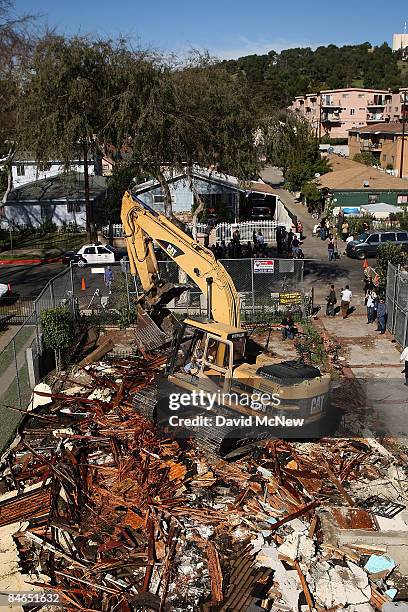 Demolition crew tears down a rented house that city officials say was used as the headquarters of the notorious Avenues gang February 4, 2009 in the...