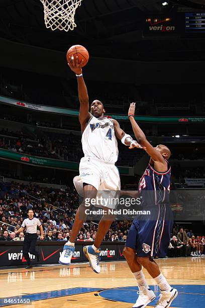 Antawn Jamison of the Washington Wizards shoots against Trenton Hassell of the New Jersey Nets at the Verizon Center on February 4, 2009 in...