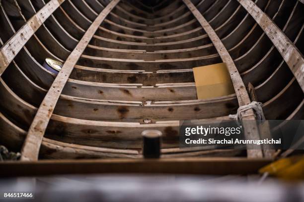 hull of a half-built wooden boat in a shipyard - shipyard stock-fotos und bilder