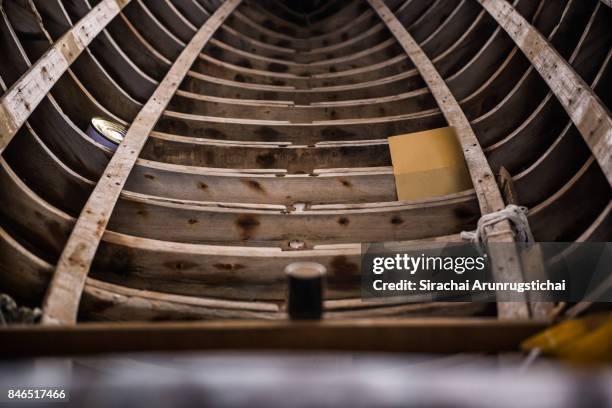 hull of a half-built wooden boat in a shipyard - wooden boat stock pictures, royalty-free photos & images