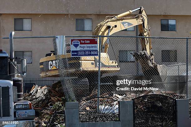 Demolition crew tears down a rented house that city officials say was used as the headquarters of the notorious Avenues gang February 4, 2009 in the...