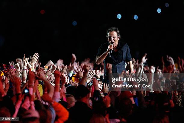 Musician Bruce Springsteen and the E Street Band perform at the Bridgestone halftime show during Super Bowl XLIII between the Arizona Cardinals and...