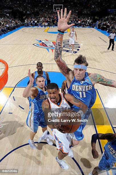 Earl Watson of the Oklahoma City Thunder goes to the basket against Chris Andersen of the Denver Nuggets at the Ford Center on February 4, 2009 in...