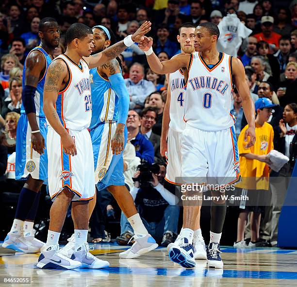 Earl Watson and Russell Westbrook of the Oklahoma City Thunder give each other high fives during the game against the Denver Nuggets at the Ford...