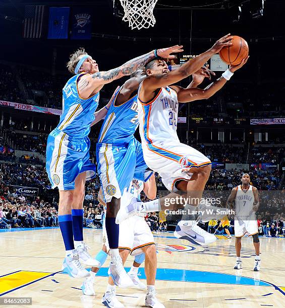 Earl Watson of the Denver Nuggets goes to the basket against Chris Andersen and Johan Petro of the Oklahoma City Thunder at the Ford Center on...