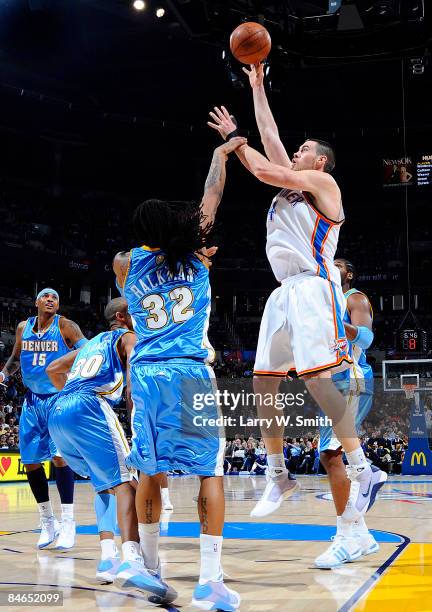 Nick Collison of the Oklahoma City Thunder goes to the basket against Renaldo Balkman of the Denver Nuggets at the Ford Center on February 4, 2009 in...