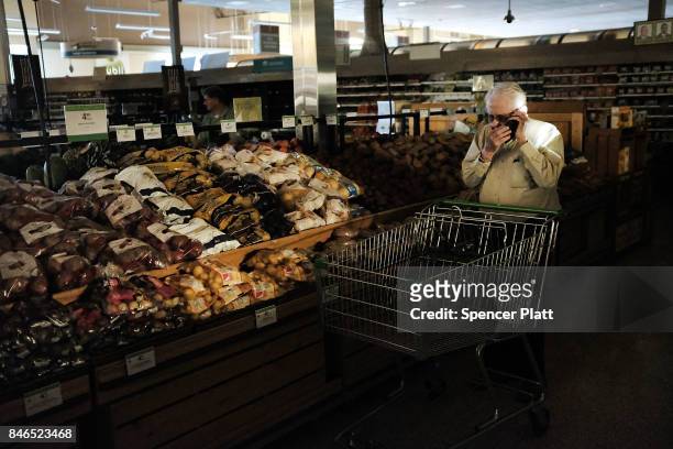 Man shops in a supermarket, one of the few open, with limited electricity three days after Hurricane Irma swept through the area on September 13,...