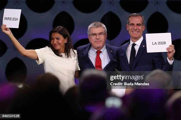Paris Mayor Anne Hidalgo, IOC President Thomas Bach and Los Angeles Mayor Eric Garcetti react after the confirmation of the tripartite agreement...