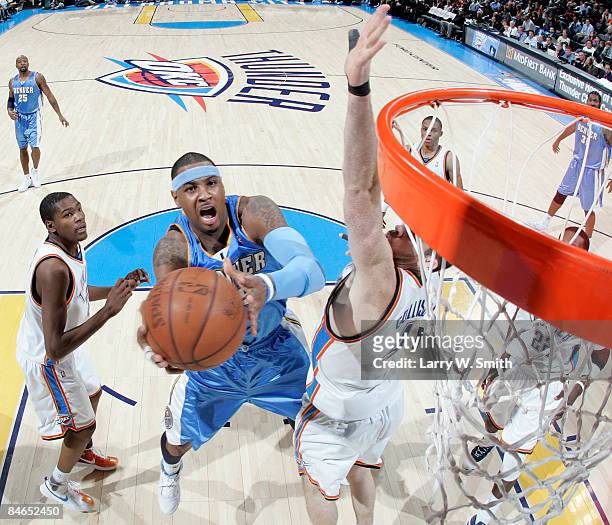 Carmelo Anthony of the Denver Nuggets goes to the basket against Nick Collison of the Oklahoma City Thunder at the Ford Center on February 4, 2009 in...